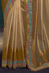 Golden ochre tissue silk saree with vertical embroidered border and tassel hem