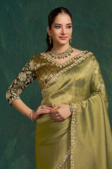 Olive metallic silk saree with gold pallu detail and embroidered neckline