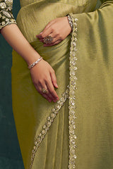 Olive metallic silk saree pleats with gold lace trim and bracelet