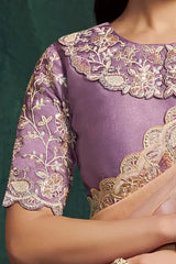 Lavender silk saree blouse with ornate gold-embroidered neckline and sleeve border