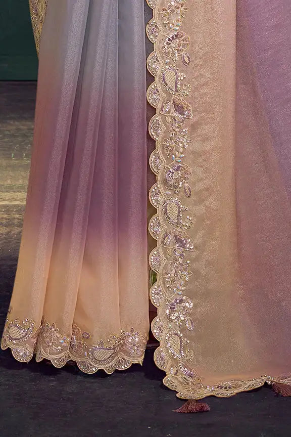 Silk saree hem with wide gold embroidery along ombre purple to blush fabric