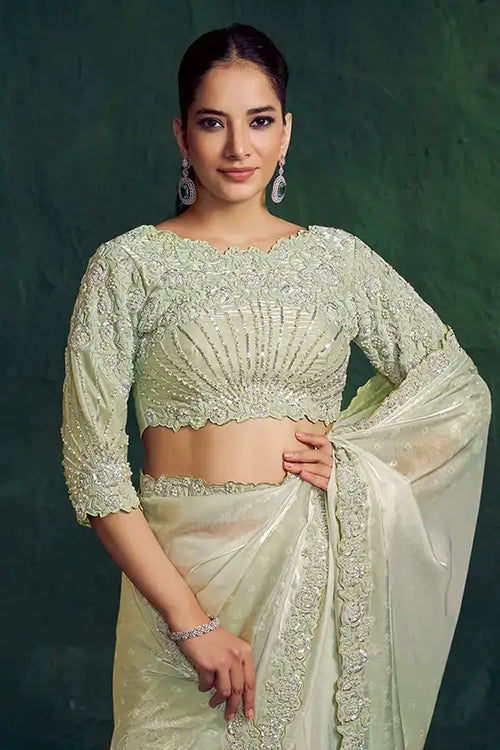 Mint sage tissue silk saree with ornate gold-toned border and 3/4 sleeve blouse