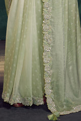 Mint sage saree fall with patterned fabric and decorative gold-toned border trim