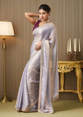 Silver satin saree with gold embellished border, styled with sleeveless maroon blouse