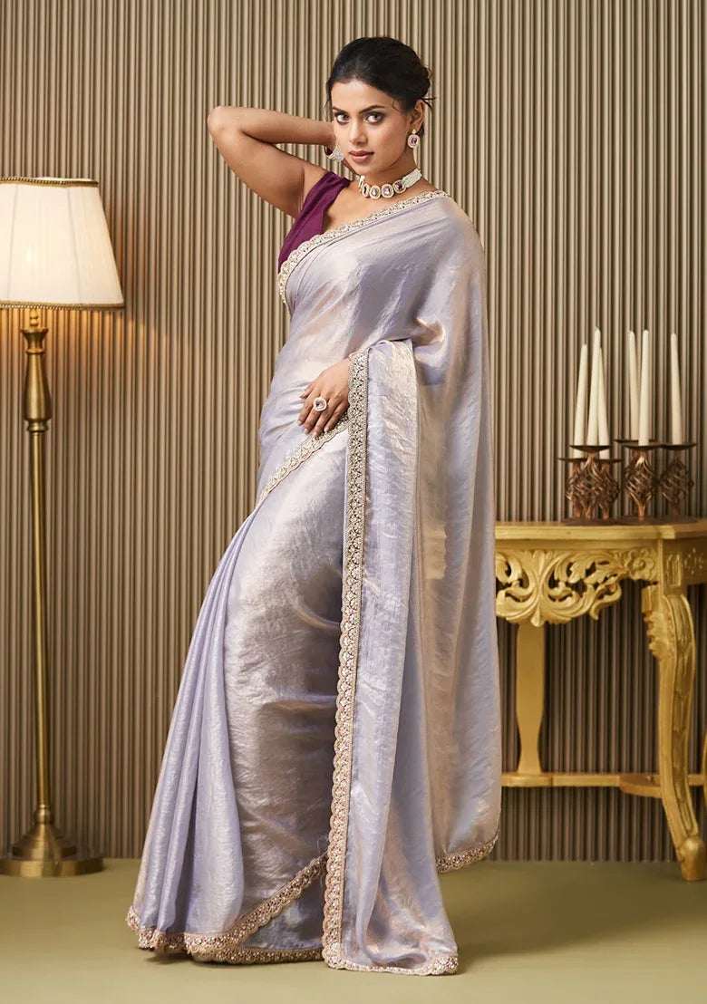 Silver satin saree with gold embellished border, styled with sleeveless maroon blouse