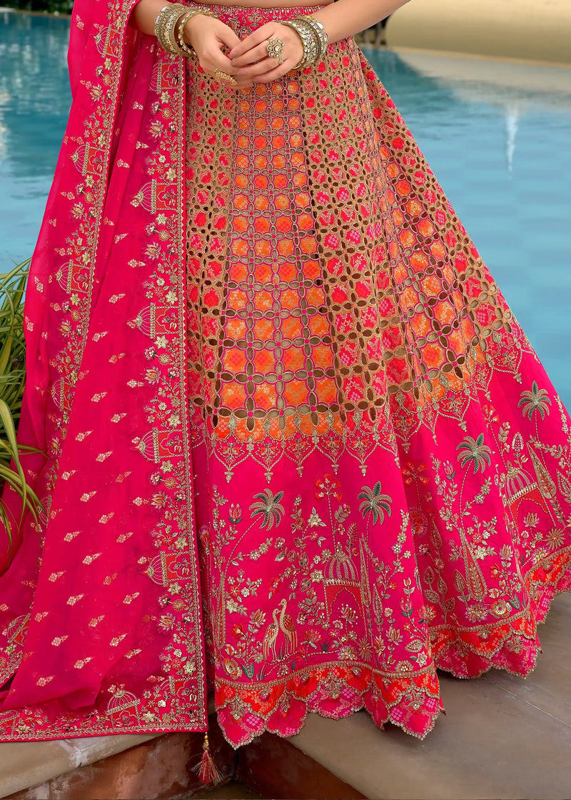 Pink lehenga skirt close-up with dense gold embroidery, scalloped hem, and border