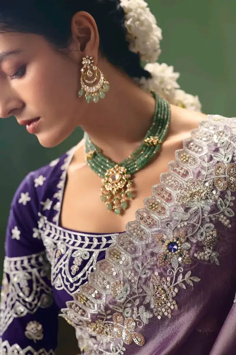 Lavender saree neckline with heavy silver embroidery and blue gemstone accents