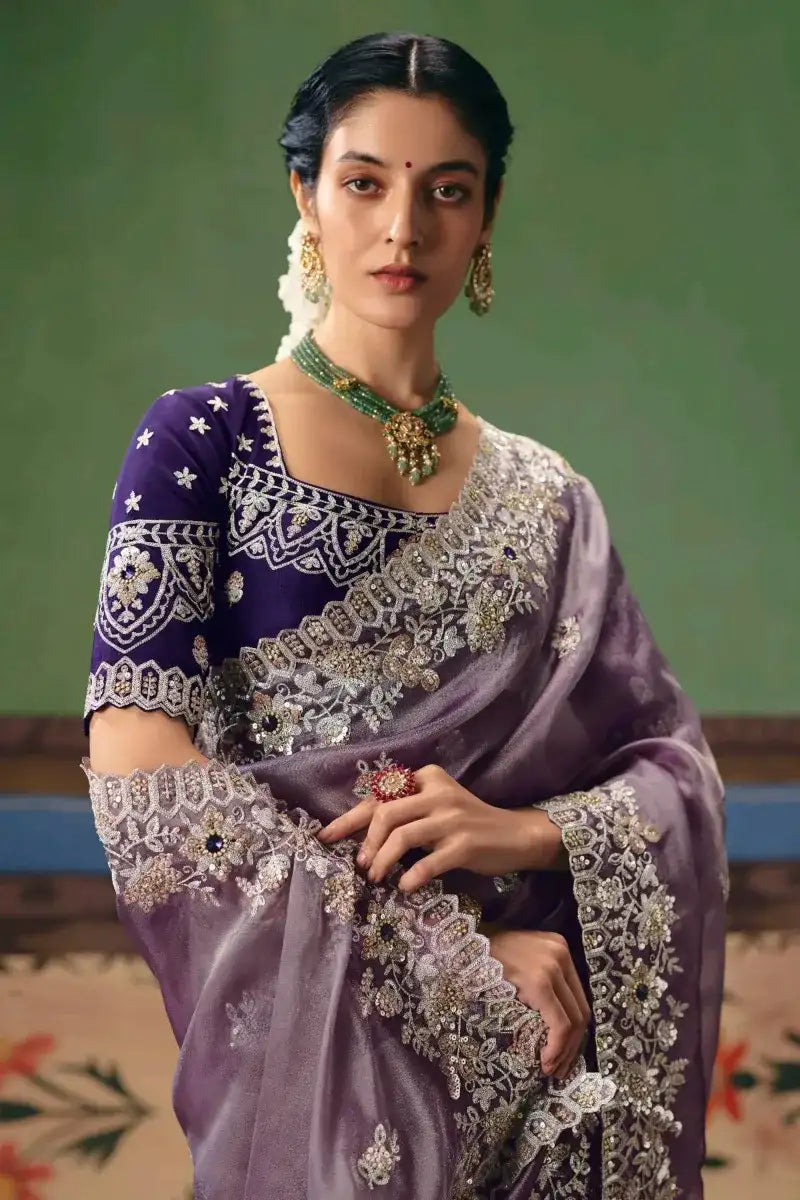 Lavender silk saree with navy blouse, star motif sleeves, and ornate silver work