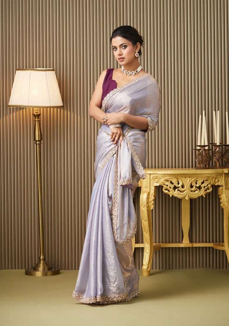 Silver satin saree with gold border drape and maroon sleeveless blouse