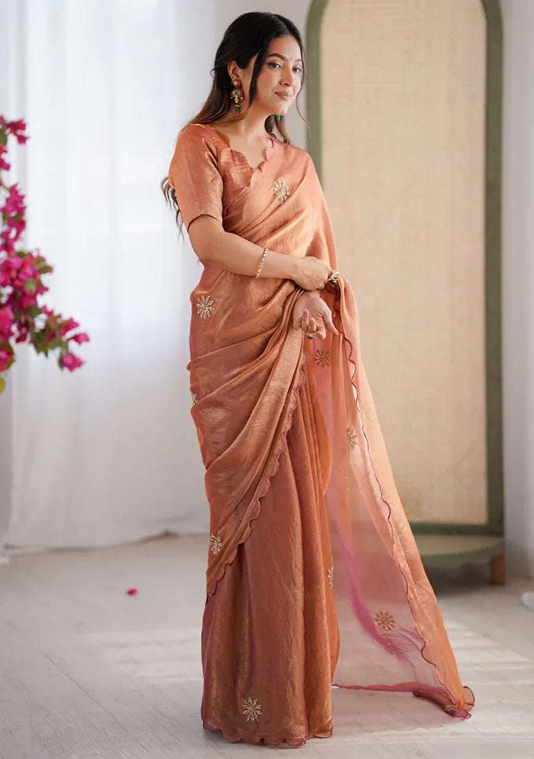 Rust satin saree with beaded motifs along the border and matching draped pallu