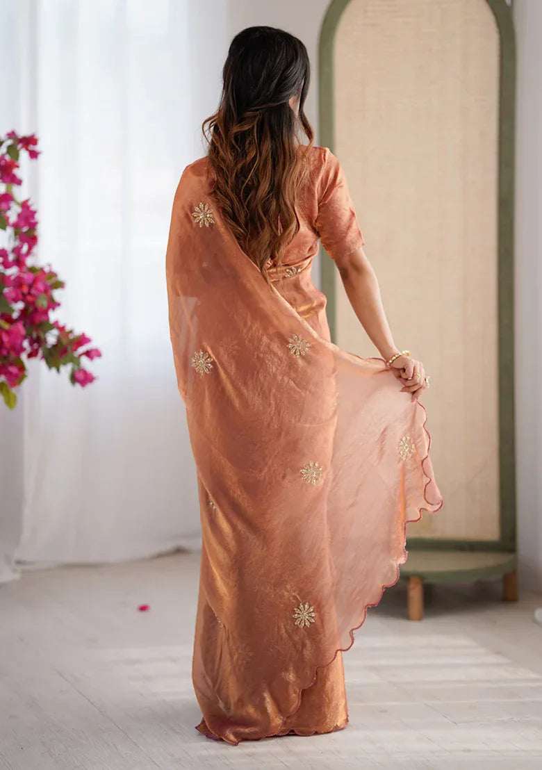 Rust satin saree, back view, with scattered beaded motifs and scalloped pallu