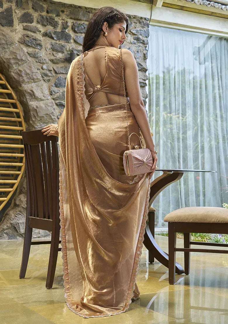 Champagne gold satin silk saree, back view with embellished blouse and trailing pallu