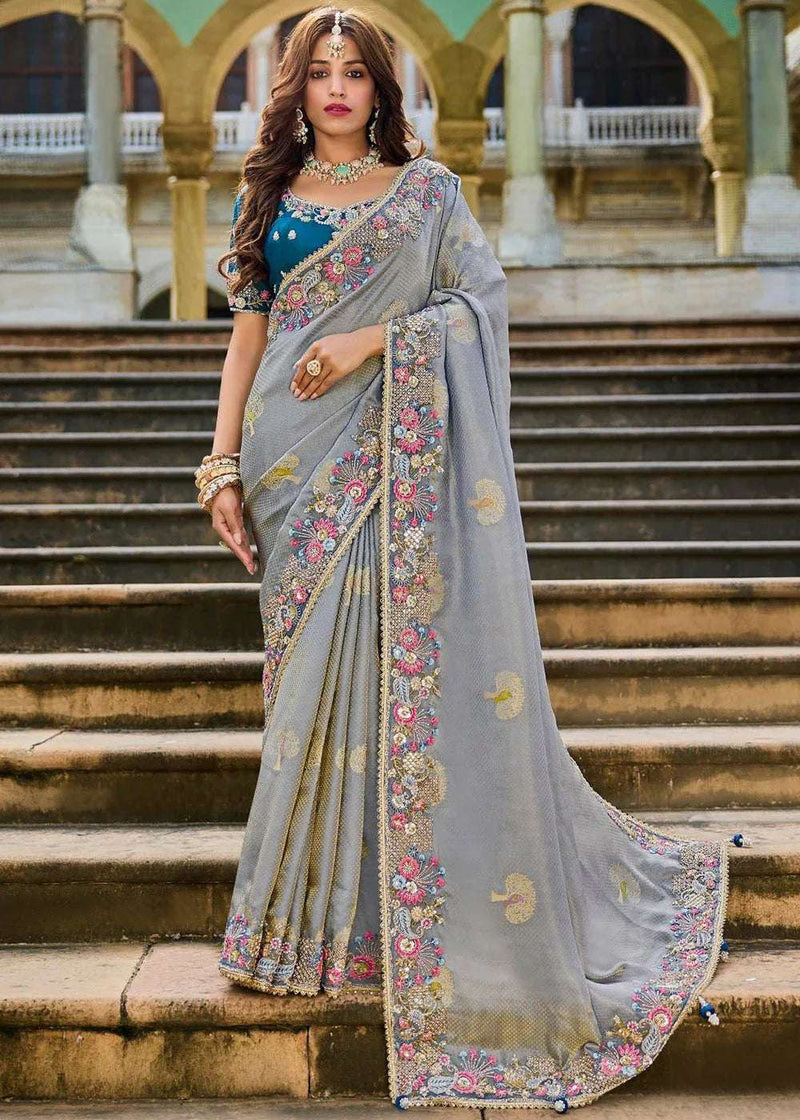 Grey silk saree with teal blouse, cutwork mirrorwork border, floral embroidery, draped