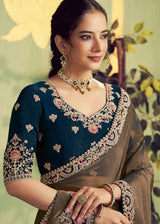 Metallic bronze saree with embroidered border, paired with dark navy blouse