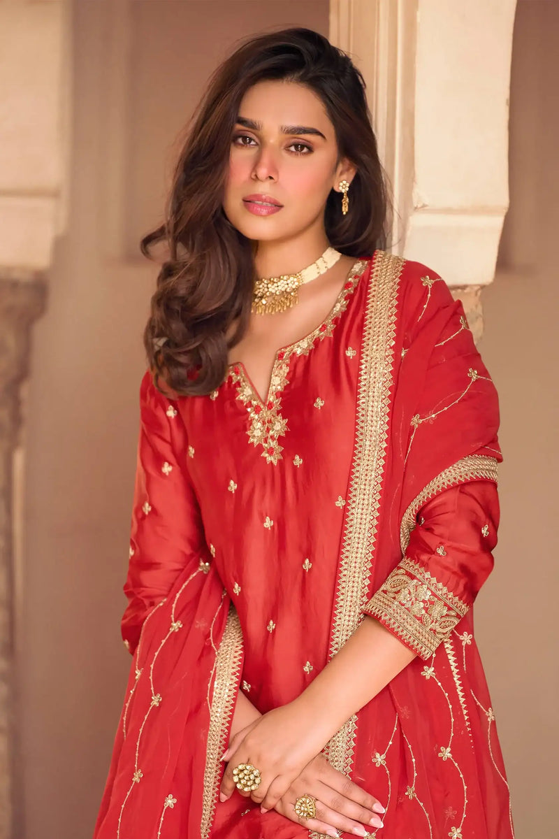 Red embroidered kurta with gold trim, long sleeves, V neckline, and matching dupatta