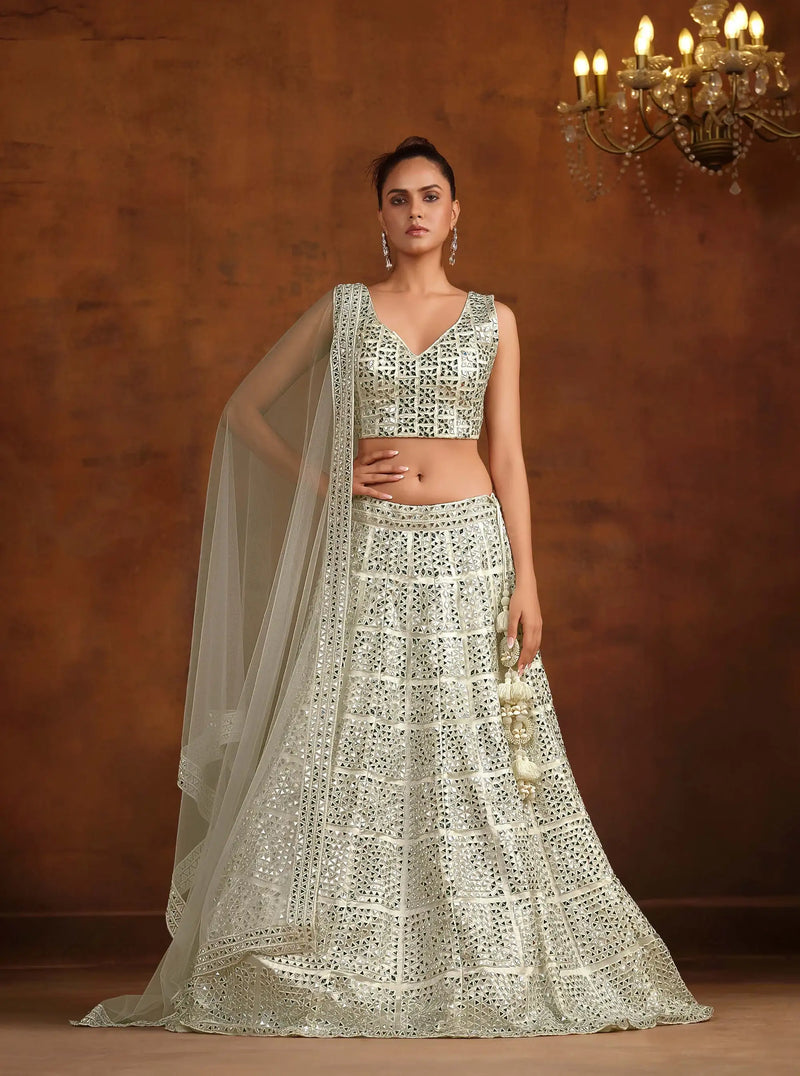 Off-white bridal lehenga set with mirror-work sleeveless blouse and tiered skirt