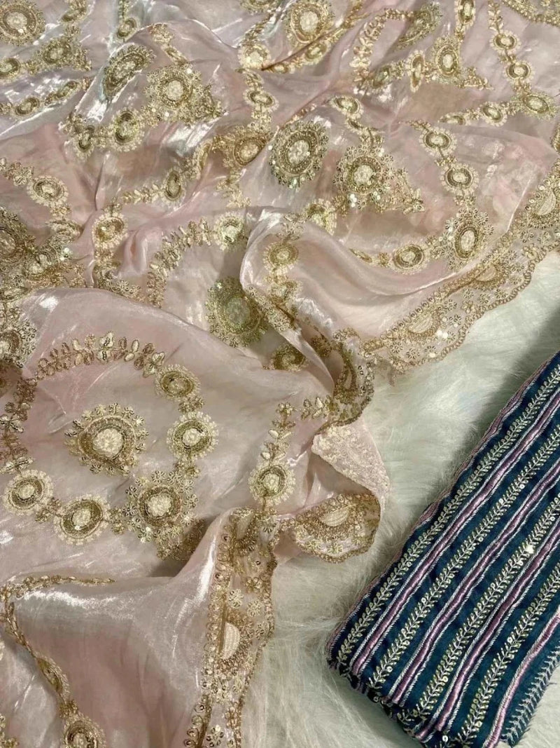 Blush pink saree fabric with gold sequin swirl motifs and dark striped border