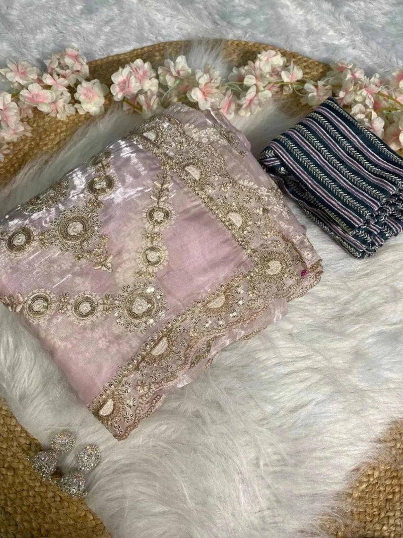 Blush pink saree fabric with gold sequin circular motifs, folded with matching blouse