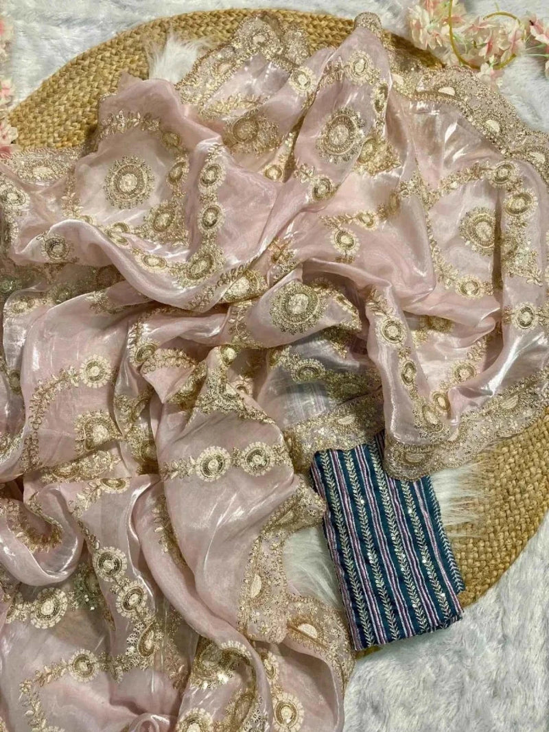 Blush pink saree fabric with gold sequin embroidery, folded with dark multicolor trim