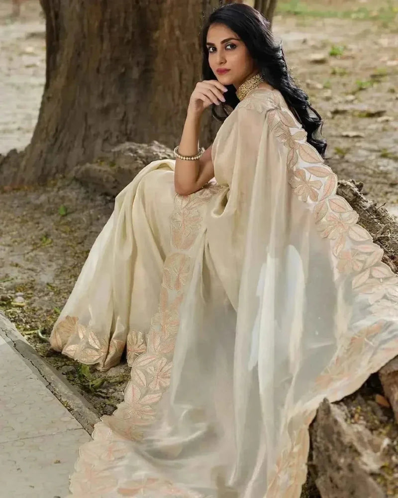 Cream organza saree with wide pleats and gold embroidered cutwork border