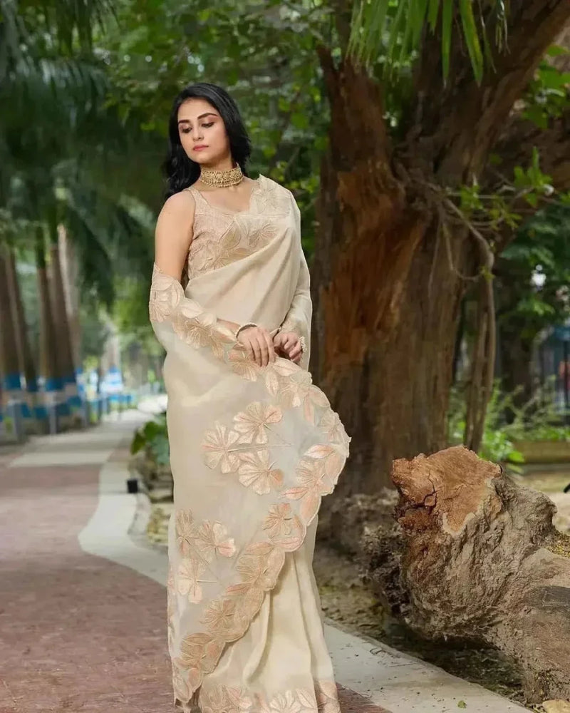 Cream organza saree with gold sequin floral embroidery at lower panel