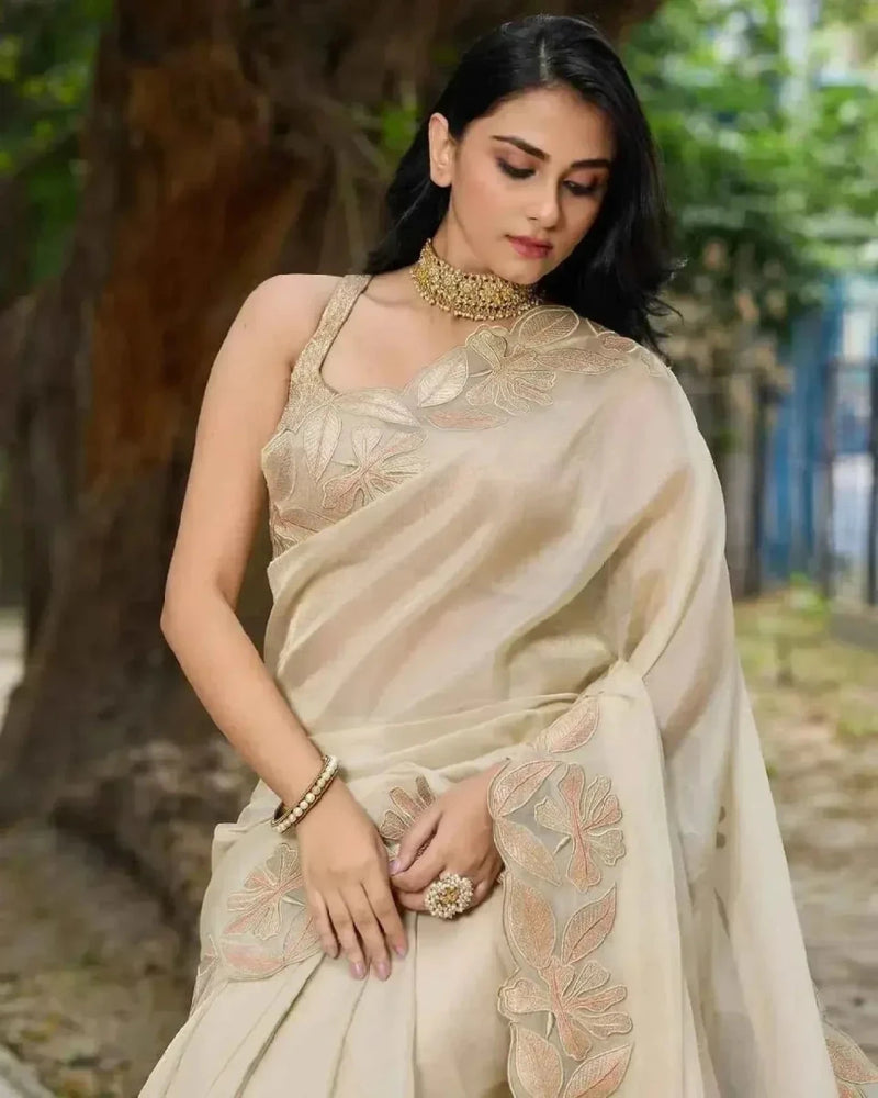 Cream saree detail view with gold sequin floral motif on bodice and pallu