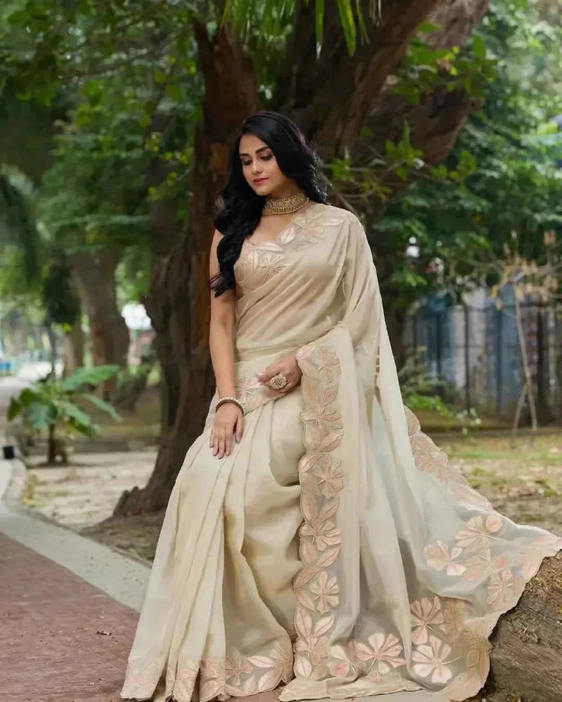 Cream organza saree with gold sequin floral work and matching border on pallu