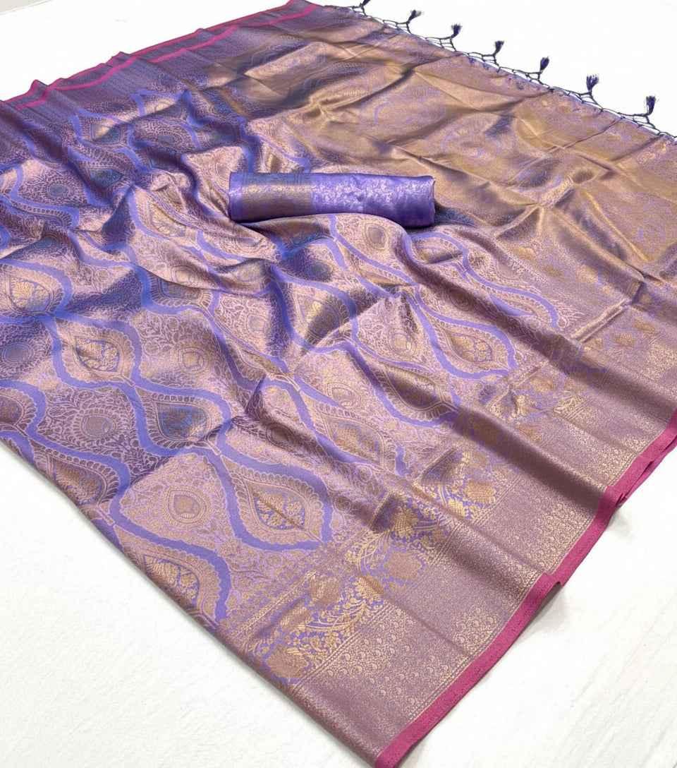 Handloom silk saree with two-tone purple and gold weave, featuring intricate floral and paisley patterns with contrast pink border