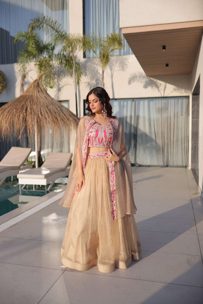 Cream lehenga set with pink embroidered blouse and sheer shrug, full skirt