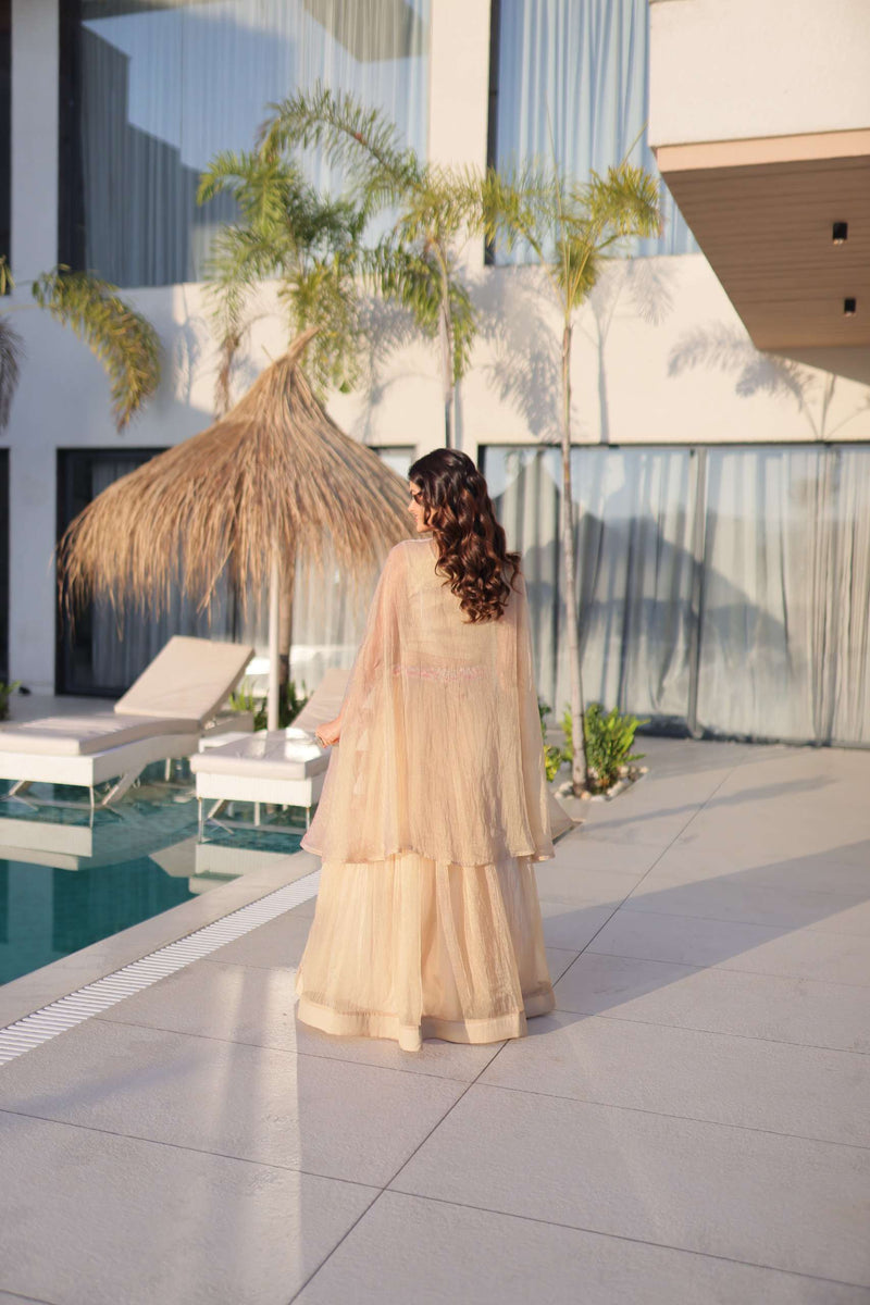 Cream lehenga with pink embroidered back blouse and sheer shrug, tiered skirt