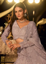 Lilac embellished net lehenga with V-neck blouse and silver-toned detailed skirt