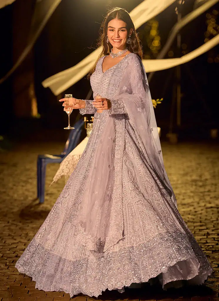 Lilac net lehenga with V-neck blouse and flowing flared skirt, embellished