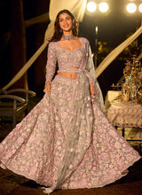 Mint floral net lehenga with fitted blouse and draped sheer dupatta, full skirt flare.