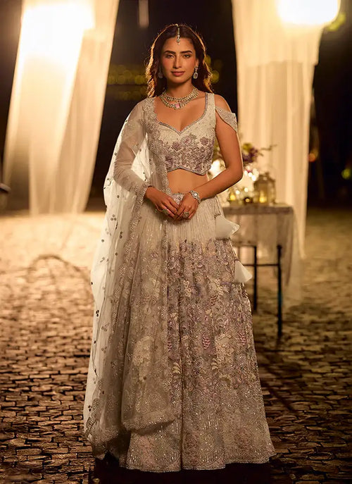 Lavender embroidered lehenga with sleeveless blouse and net dupatta, tiered skirt