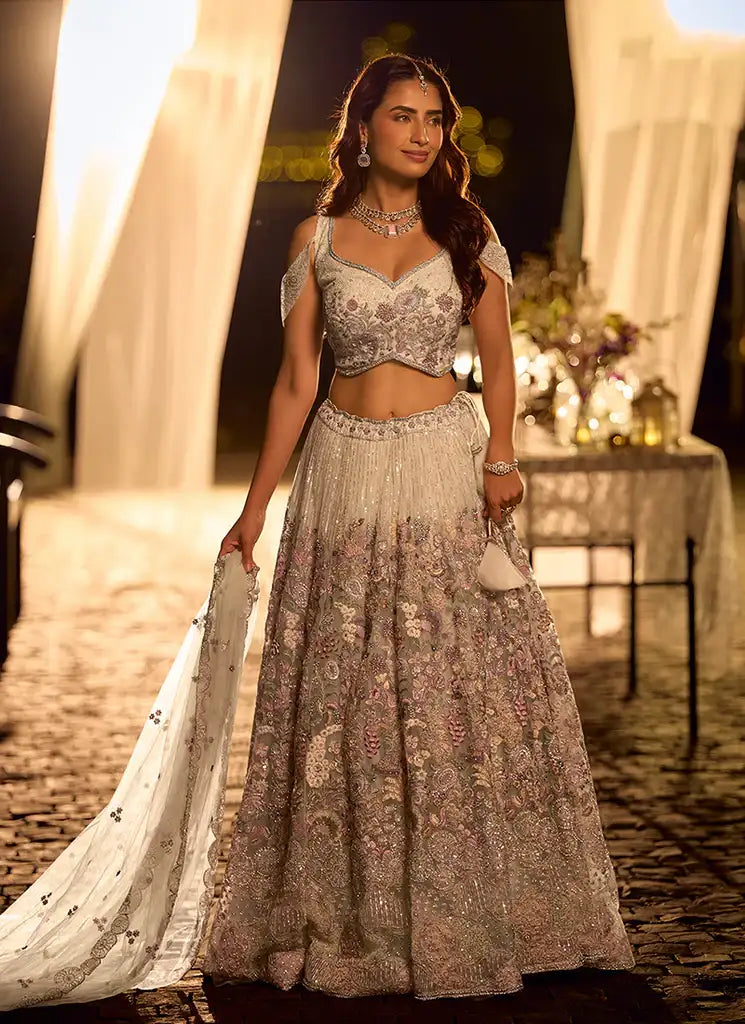 Lavender embroidered lehenga set with tiered skirt, sleeveless blouse, and net dupatta