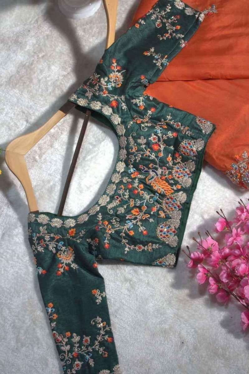 Organza mirror saree blouse on fabric, dark green floral pattern with orange drape