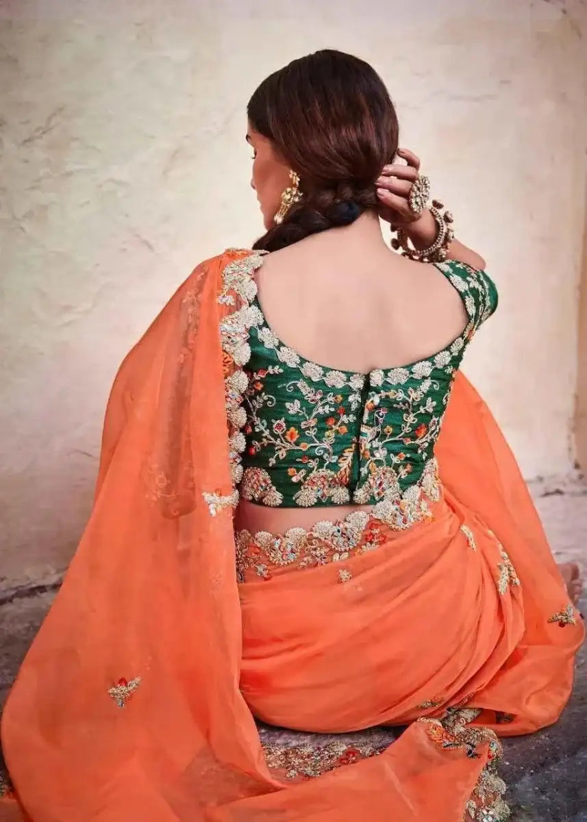 Organza mirror saree from back, dark green floral blouse with orange pallu and embellishments