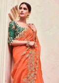 Organza mirror saree, orange drape with dark green floral blouse and silver embellishments