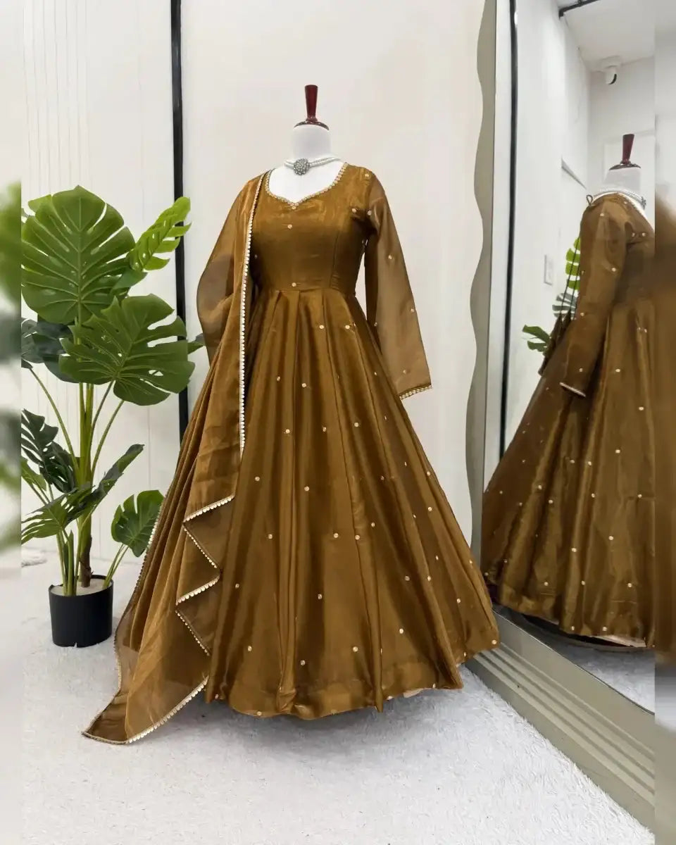 Antique bronze Anarkali suit on mannequin with long sleeves and draped dupatta