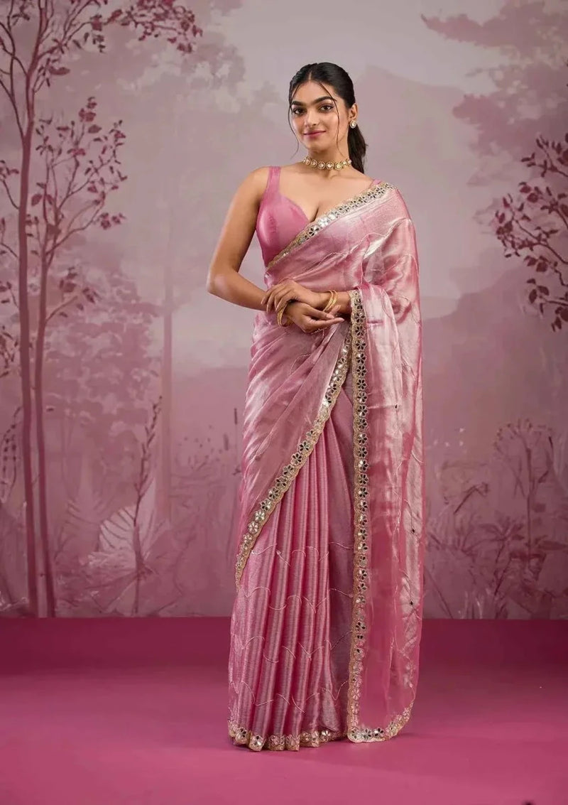 Baby pink silk saree with ornate mirror-work border and sequin trim