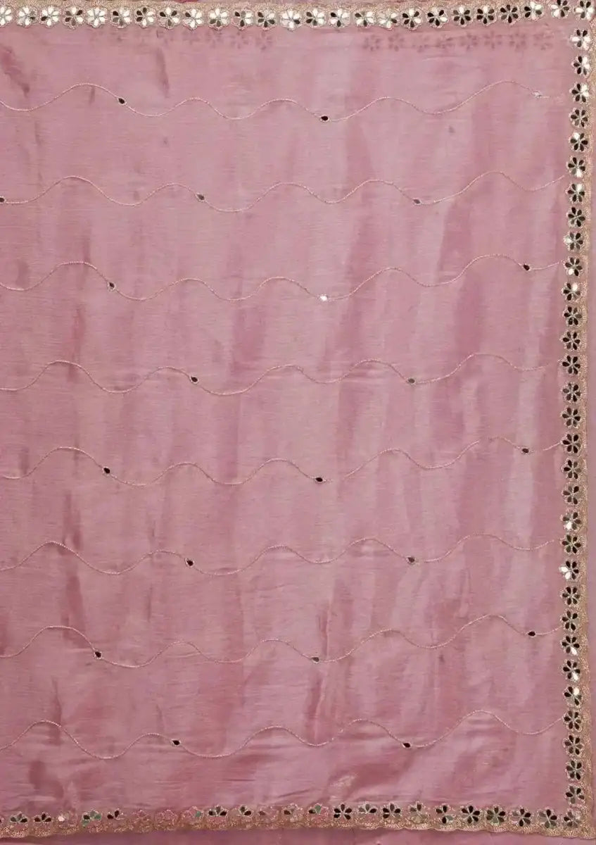 Baby pink silk saree fabric close-up with cutwork and mirror-work border