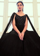 Black embroidered long gown close-up, square neckline and flared pleated skirt