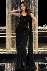 Black sleeveless cocktail saree gown with embellished neckline and draped skirt