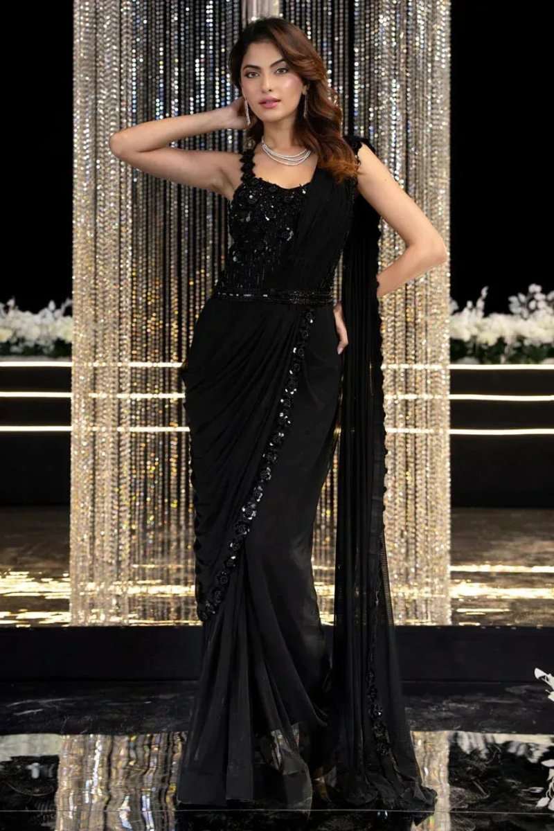 Black sleeveless embroidered gown with beaded neckline and flowing draped saree-style skirt