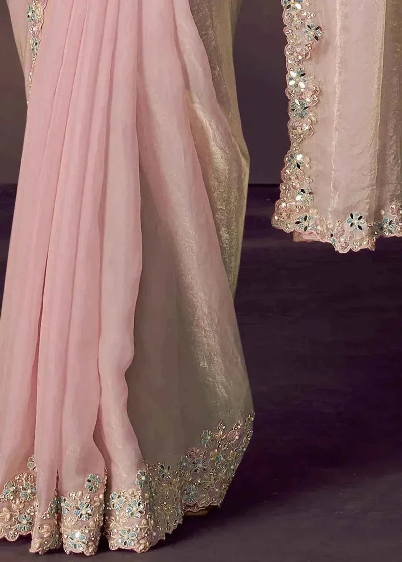 Blush pink saree hem with ornate embroidered floral border and scalloped edge