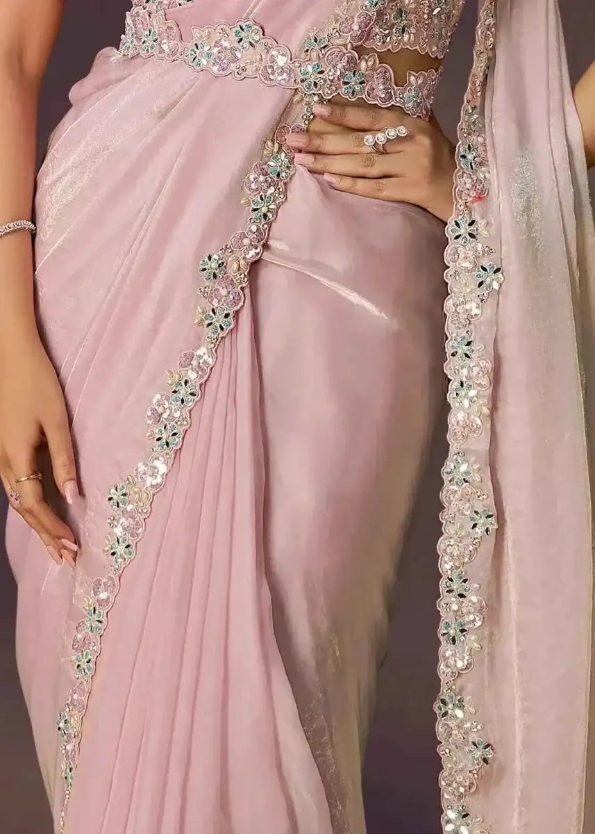 Blush pink saree drape with ornate border trim and embroidered waist detail