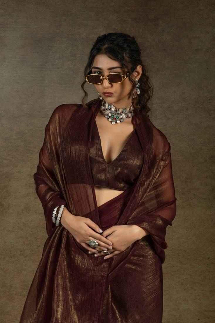 Dark brown satin chiffon saree with gold shimmer, V-neck blouse and draped pallu