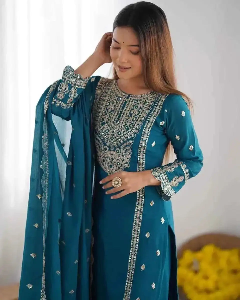 Teal embroidered kurta with ornate yoke and long sleeves, dupatta held to side