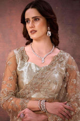 Champagne gold embroidered satin saree with net sleeves and beadwork neckline