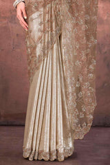Champagne gold satin saree with foil sheen and floral net border at hem
